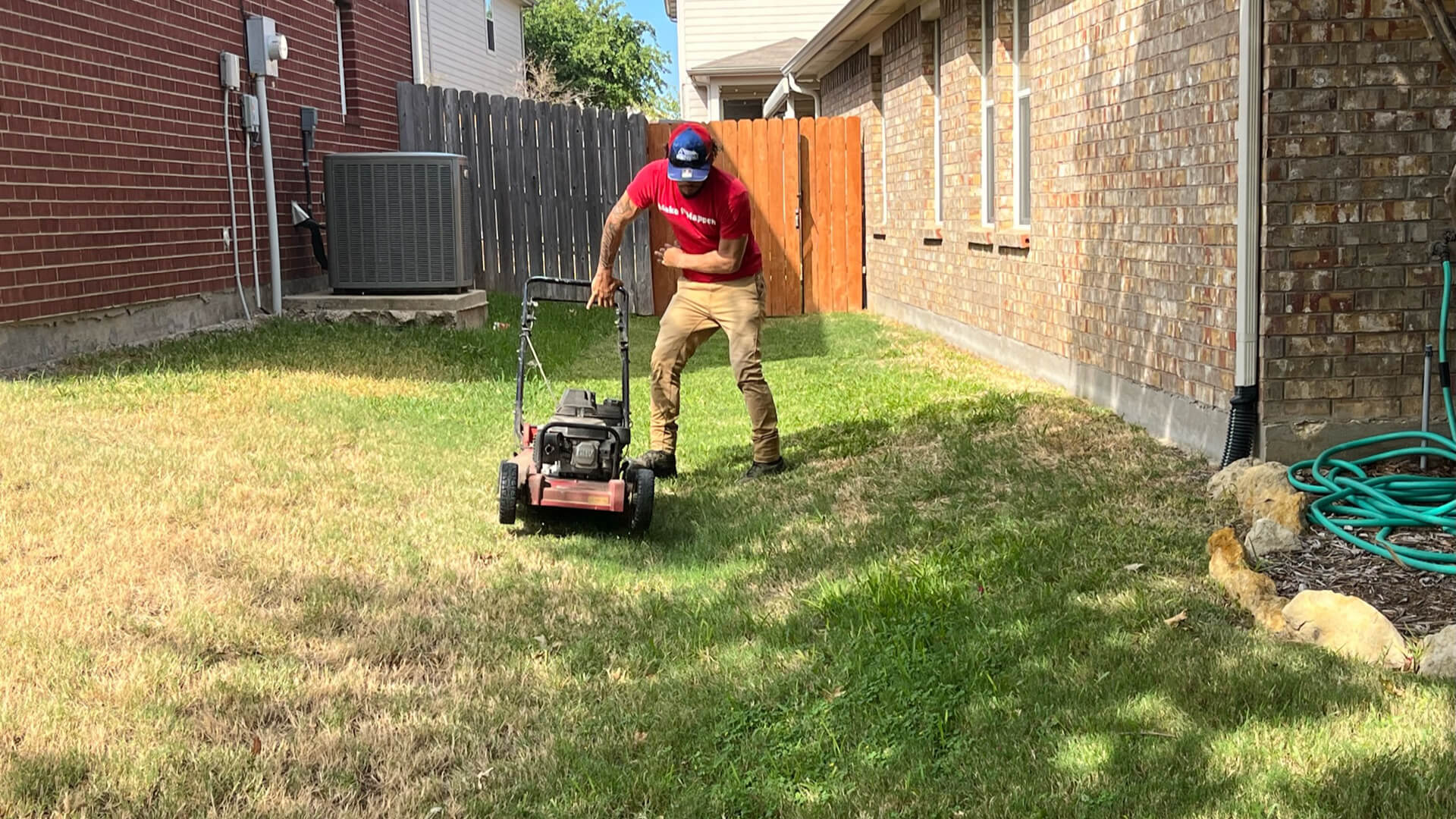 First Cut Lawn Services worker mowing a lawn in Keller, Texas.