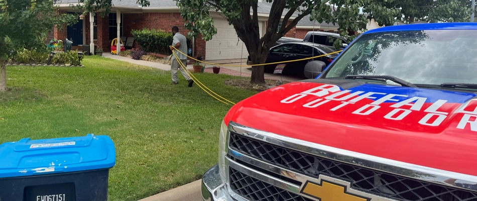 Professional from Buffalo Outdoor applying fertilizer to lawn in Blue Mound, TX.