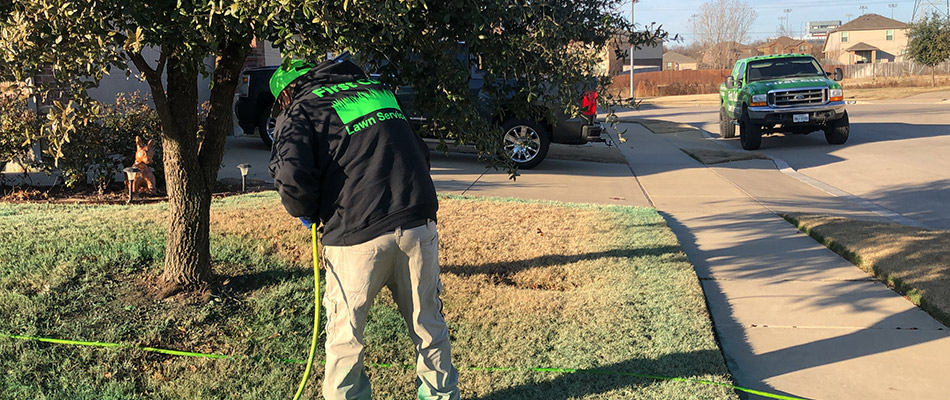 Professional applying lawn treatment in Lake Worth, TX.