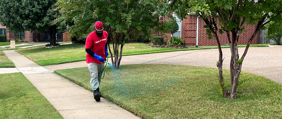 A First Cut Lawn Services professional spraying lawn in Colleyville, TX.